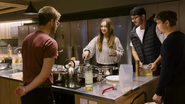 Students cooking in the student kitchen at UID.