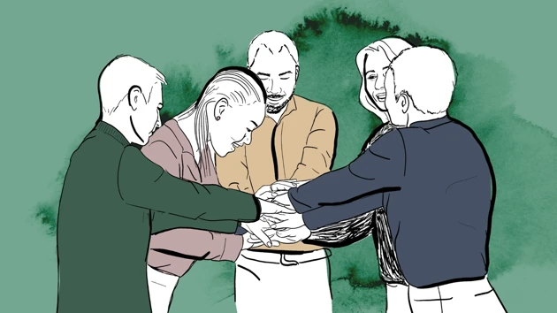 Grupp med människor som lagt sina händer på varandra.